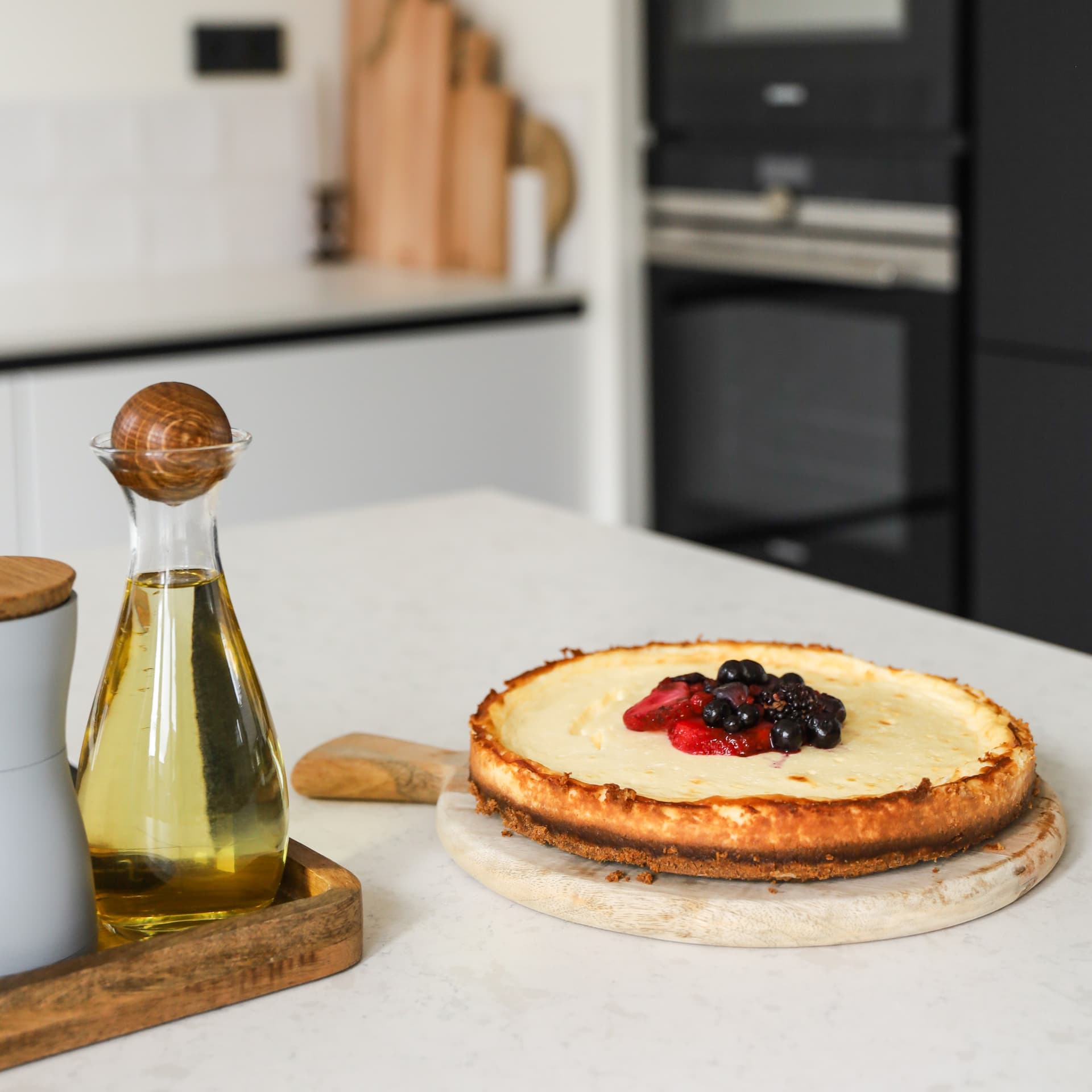 De keuken van Denise_2.jpg Cheesecake gepresenteerd op een kookeiland met een grijsmarmer werkblad
